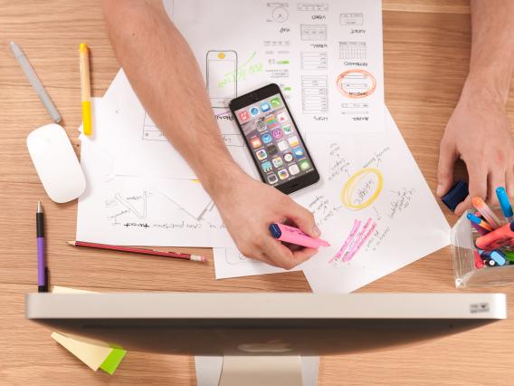 aerial view of desk with papers and iphone