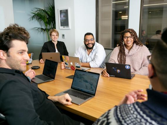 a diverse group of people sitting around a conference table